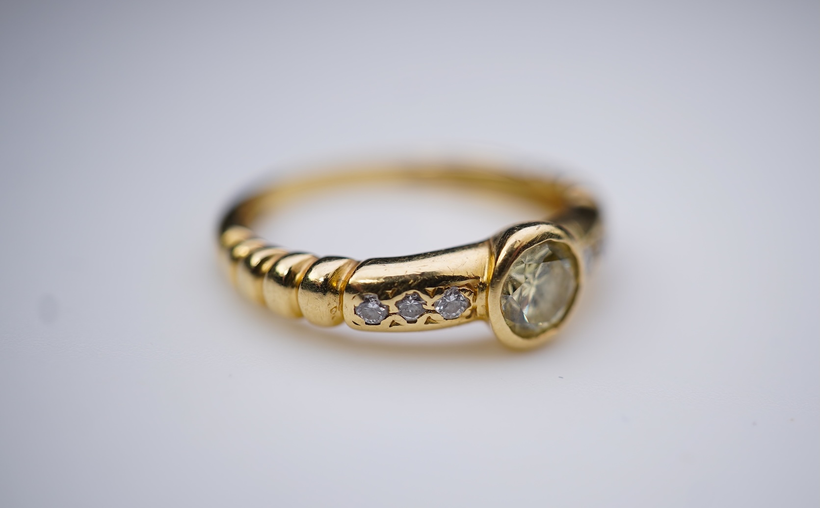 A yellow diamond and diamond ring